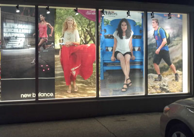 A retailer uses fabric window displays. They backlight them at night for extra effect! Fabric banners in a store window